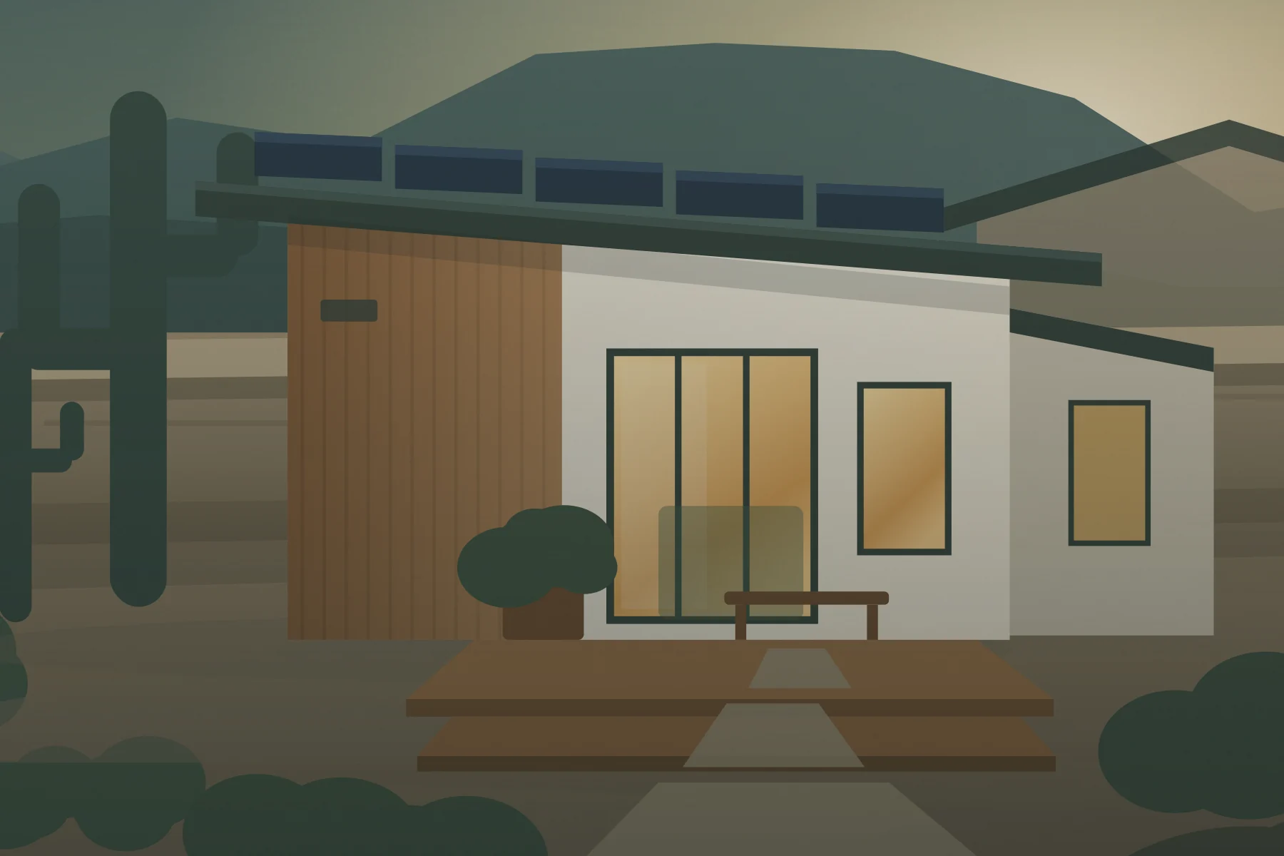 The same casita after dark, windows lit warm against the desert sky.
